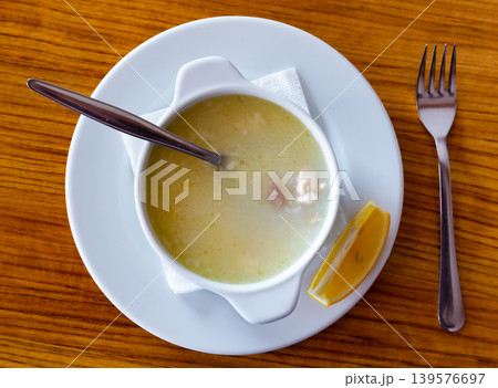 Traditional turkish chicken broth soup on wooden table top view 139576697