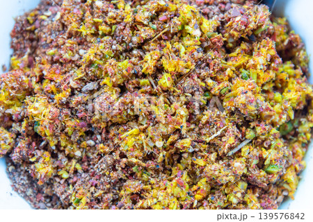 Closeup of spicy Thai chili herb seasoning mix with crushed spices and colorful ingredients showing rich texture and traditional Asian food preparation Closeup of spicy Thai chili herb seasoning mix with crushed spices and colorful ingredients showing rich texture and traditional Asian food preparation 139576842