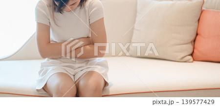 woman having abdomen ache due to Stomach pain, digestion with constipation or Diarrhea from food poisoning, female problem and Endometriosis, Hysterectomy, Stomachache and Menstrual on sofa at home woman having abdomen ache due to Stomach pain, digestion with constipation or Diarrhea from food poisoning, female problem and Endometriosis, Hysterectomy, Stomachache and Menstrual on sofa at home 139577429