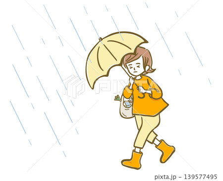 雨風強い中、傘をさしている女性 139577495