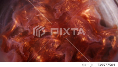 Smoke blur stream. Shimmering haze. Orange brown ink fume explosion in liquid. Sparkling swirl blending on color abstract background. Smoke blur stream. Shimmering haze. Orange brown ink fume explosion in liquid. Sparkling swirl blending on color abstract background. 139577504