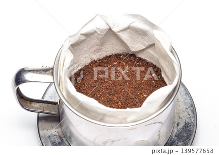 grounded coffee from the grinding machine on white background grounded coffee from the grinding machine on white background 139577658