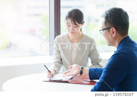 契約書にサインをする女性 契約書にサインをする女性 139578107