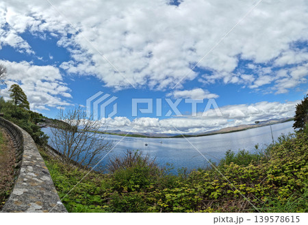 Wide panoramic lake landscape with dramatic clouds Wide panoramic lake landscape with dramatic clouds 139578615