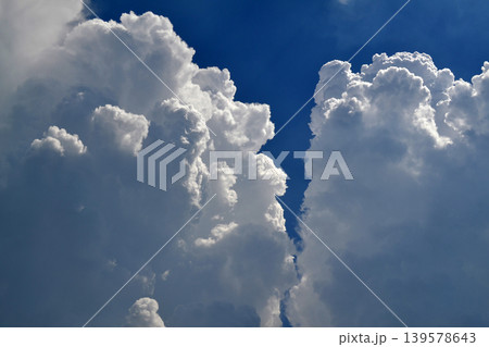 Towering Cumulus Clouds Against Deep Blue Sky Towering Cumulus Clouds Against Deep Blue Sky 139578643