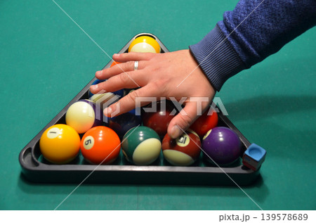 Hand Racking Pool Balls on Billiards Table Hand Racking Pool Balls on Billiards Table 139578689