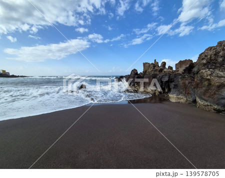 Waves Breaking on Black Sand Beach 139578705