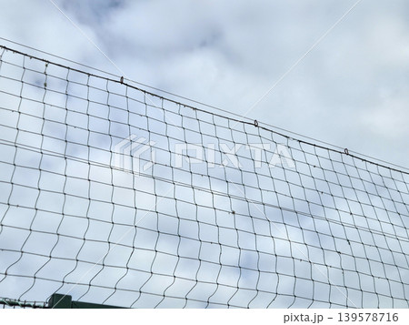 Wire fence against cloudy sky Wire fence against cloudy sky 139578716
