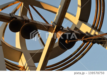 Modern metal sculpture with hanging bells Modern metal sculpture with hanging bells 139578750