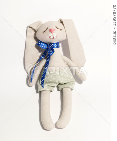 Handmade stuffed rabbit toy with blue ribbon Handmade stuffed rabbit toy with blue ribbon 139578770