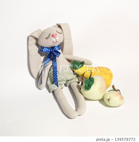 Handmade stuffed bunny with fruit toys on white Handmade stuffed bunny with fruit toys on white 139578772