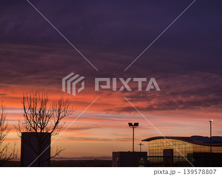 Dramatic sunset sky over modern building silhouette 139578807