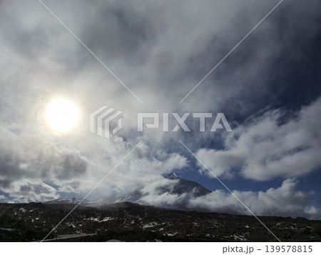 Sunlight Breaking Through Clouds Over Mountain Landscape 139578815