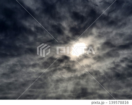 Bright sun behind dramatic dark clouds 139578816
