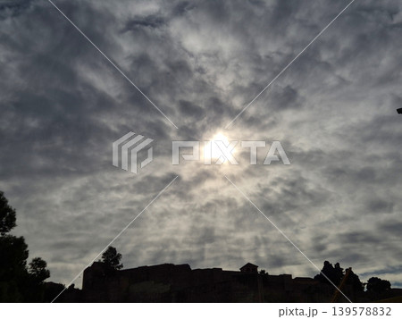 Bright sun behind dramatic cloudy sky Bright sun behind dramatic cloudy sky 139578832