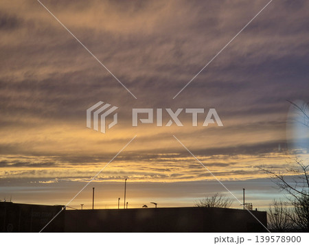 Golden sunset sky over silhouetted rooftops Golden sunset sky over silhouetted rooftops 139578900