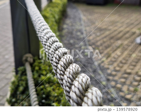 Close-Up of Braided Rope Barrier Outdoors Close-Up of Braided Rope Barrier Outdoors 139578920