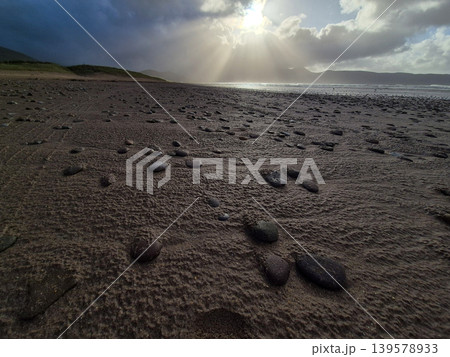 Rocky beach under dramatic sun and clouds Rocky beach under dramatic sun and clouds 139578933