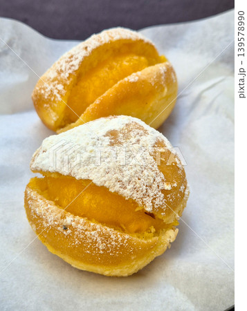 Powdered sugar filled pastries on parchment paper Powdered sugar filled pastries on parchment paper 139578990
