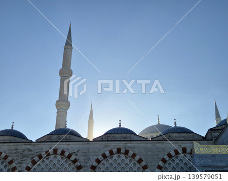 Mosque minarets and domes against clear sky Mosque minarets and domes against clear sky 139579051