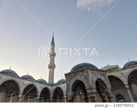 Mosque courtyard with minaret and domes against sky 139579052