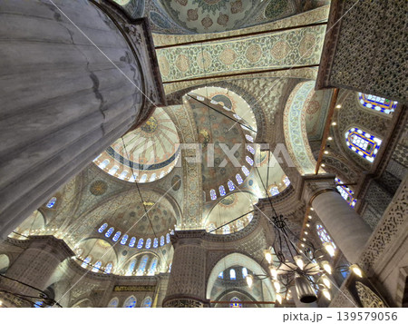 Ornate mosque interior with domes and columns 139579056