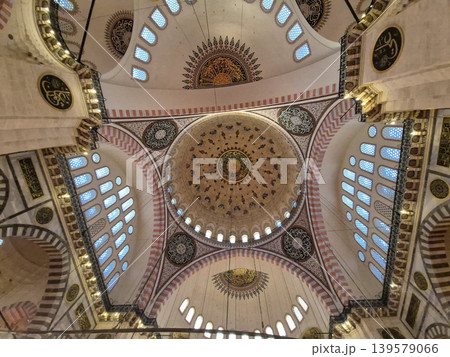Ornate mosque ceiling with decorative domes and windows Ornate mosque ceiling with decorative domes and windows 139579066