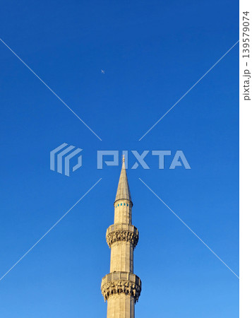 Tall minaret against clear blue sky Tall minaret against clear blue sky 139579074