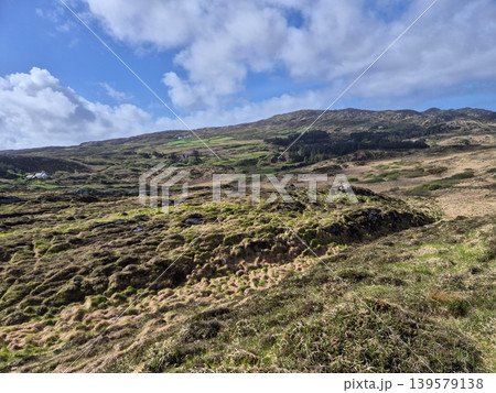Rugged hillside landscape under dramatic cloudy sky 139579138