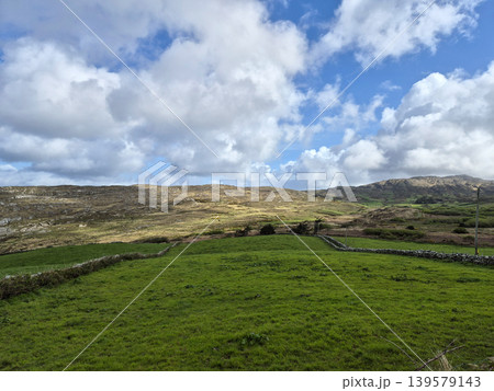 Green countryside hills under dramatic cloudy sky 139579143