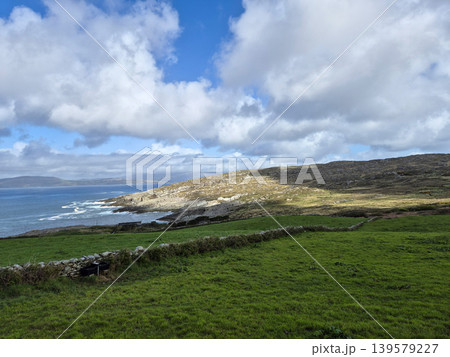 Coastal landscape with green hills and cloudy sky Coastal landscape with green hills and cloudy sky 139579227