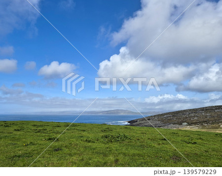 Green coastal landscape with blue sky and clouds Green coastal landscape with blue sky and clouds 139579229