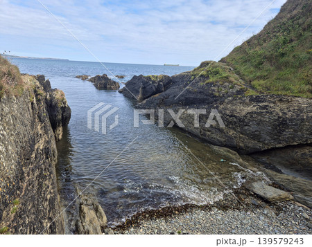 Rocky Coastal Cove With Calm Sea Rocky Coastal Cove With Calm Sea 139579243