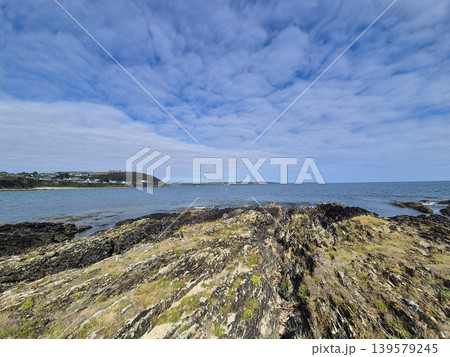 Rocky coastline with calm sea and cloudy sky Rocky coastline with calm sea and cloudy sky 139579245
