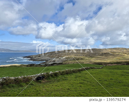 Coastal landscape with green fields and dramatic clouds Coastal landscape with green fields and dramatic clouds 139579274