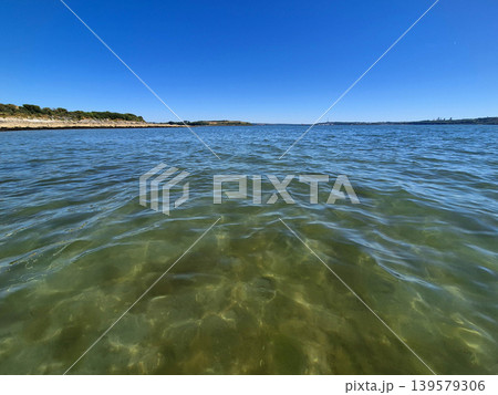 Calm coastal water under clear blue sky Calm coastal water under clear blue sky 139579306