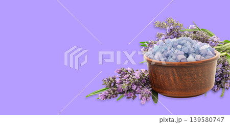 Lavender flowers and crystals sit in a wooden bowl Lavender flowers and crystals sit in a wooden bowl 139580747