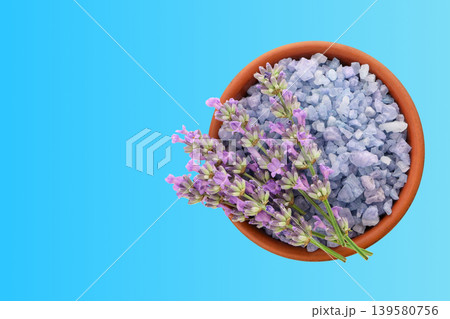 Bowl filled with lavender flowers and crystals on blue surface Bowl filled with lavender flowers and crystals on blue surface 139580756
