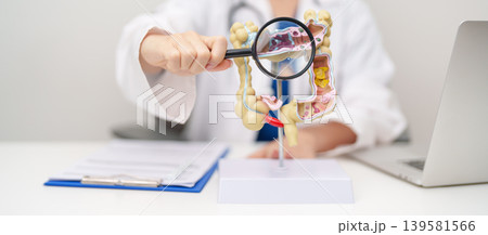 Doctor with human Colon anatomy model. Colonic disease, Large Intestine, Colorectal cancer, Ulcerative colitis, Diverticulitis, Irritable bowel syndrome, Digestive system and Healthcare concept Doctor with human Colon anatomy model. Colonic disease, Large Intestine, Colorectal cancer, Ulcerative colitis, Diverticulitis, Irritable bowel syndrome, Digestive system and Healthcare concept 139581566