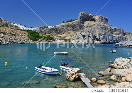 Golden sandy beach on Rhodes, Greece, with gentle waves and blue horizon, ideal holiday destination. Golden sandy beach on Rhodes, Greece, with gentle waves and blue horizon, ideal holiday destination. 139581615