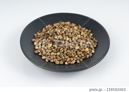 Hemp seeds, cannabis grains, marijuana kernels, oil hempseeds pile Hemp seeds, cannabis grains, marijuana kernels, oil hempseeds pile 139582003