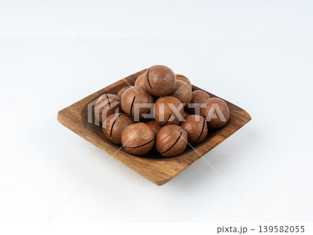Macadamia nuts isolated. Natural raw peeled macadamia seeds and shells Macadamia nuts isolated. Natural raw peeled macadamia seeds and shells 139582055