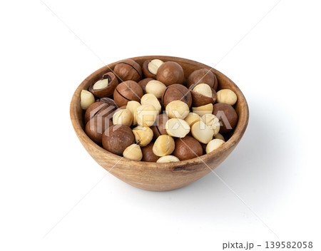 Macadamia nuts isolated. Natural raw peeled macadamia seeds and shells Macadamia nuts isolated. Natural raw peeled macadamia seeds and shells 139582058