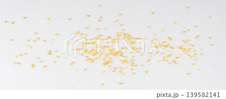 Raw millet grains pile isolated. Little yellow cereal, natural foxtail small seeds Raw millet grains pile isolated. Little yellow cereal, natural foxtail small seeds 139582141
