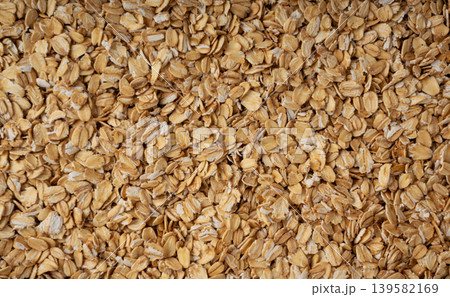 Oat flakes textured pattern, rolled oatmeal macro background Oat flakes textured pattern, rolled oatmeal macro background 139582169