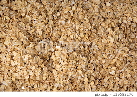 Oat flakes textured pattern, rolled oatmeal macro background Oat flakes textured pattern, rolled oatmeal macro background 139582170