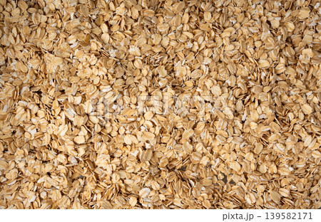 Oat flakes textured pattern, rolled oatmeal macro background Oat flakes textured pattern, rolled oatmeal macro background 139582171