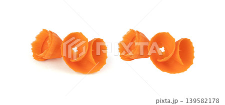 Thin carrot strips swirled in a rose flower shape isolated. Carrot slices for salad decoration Thin carrot strips swirled in a rose flower shape isolated. Carrot slices for salad decoration 139582178