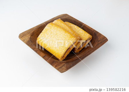 Fig roll bar, square sugar cookies with fruit filling isolated Fig roll bar, square sugar cookies with fruit filling isolated 139582216