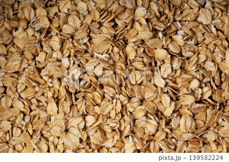 Oat flakes textured pattern, rolled oatmeal macro background Oat flakes textured pattern, rolled oatmeal macro background 139582224